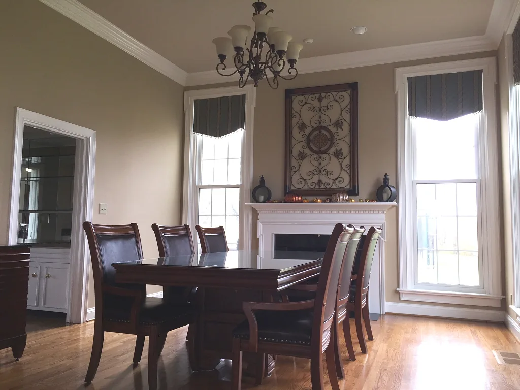 The dining room set with round tables and chairs beneath a chandelier