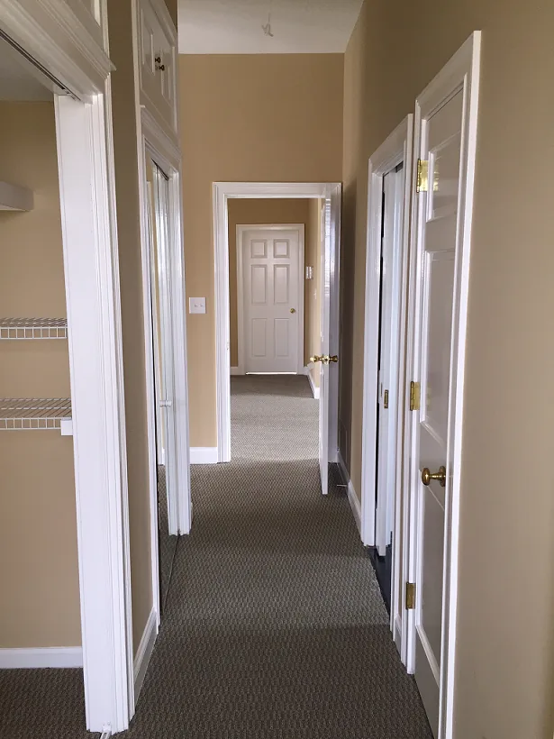 A bright interior hallway connecting the clubhouse rooms