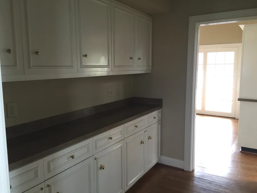 A second view of the kitchen showing the counter run and service window