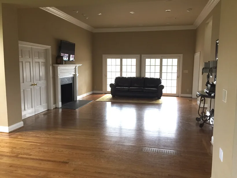 The main gathering room, with hardwood floors, tall windows and a seating area